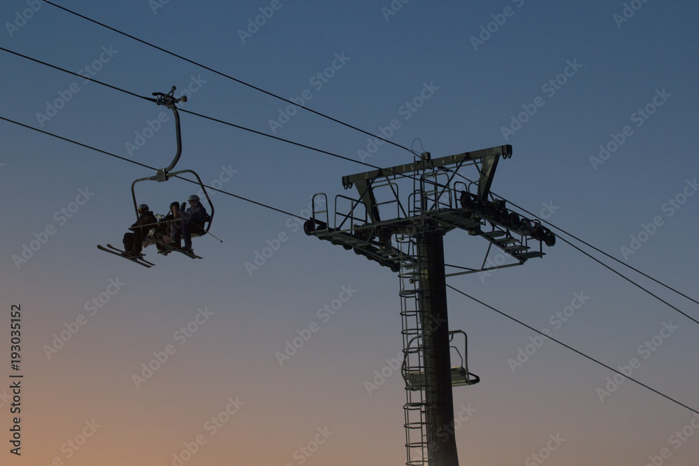 Cable car on sky resort against evening sky, silhouette Cable car on sky resort against evening sky, silhouette