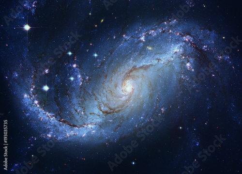 Star forming region, spiral galaxy NGC 1672, young blue stars. Elements of this image furnished by NASA. Retouched image. photo
