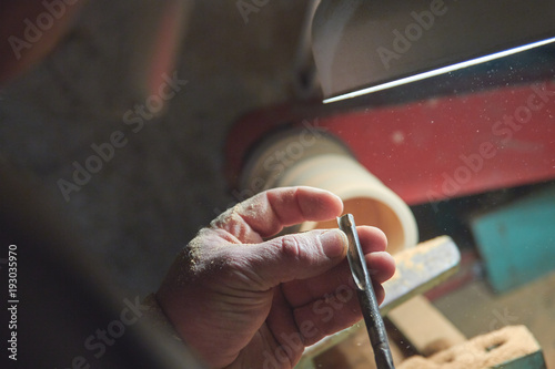 A man in the Studio hones wood blanks on a woodworking machine. turning wood on a lathe