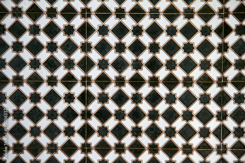 Azulejos / fondo de azulejos Árabe formando un mosaico de estrellas y rombos verde, típico de Marruecos  photo