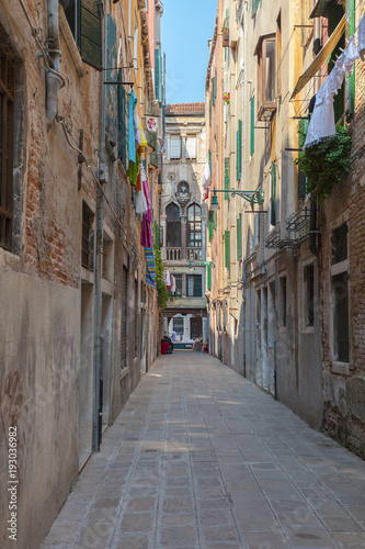 One of the many streets of Venice with many cafes, shops, tourists, Italy. Venice is a popular tourist destination of Europe. © LALSSTOCK