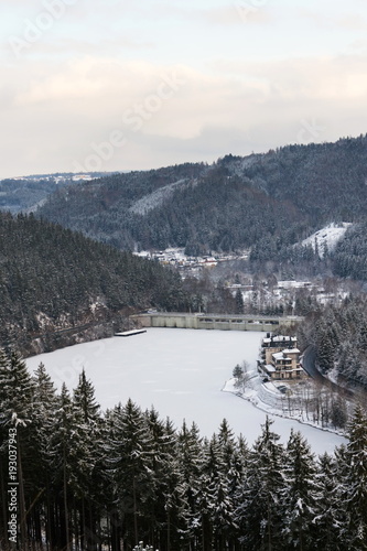 Aerial view of concrete Brezova dam with hydroelectric power plant and road to Karlovy Vary from Jungmann gazebo, snowy winter day, Czech Republic photo