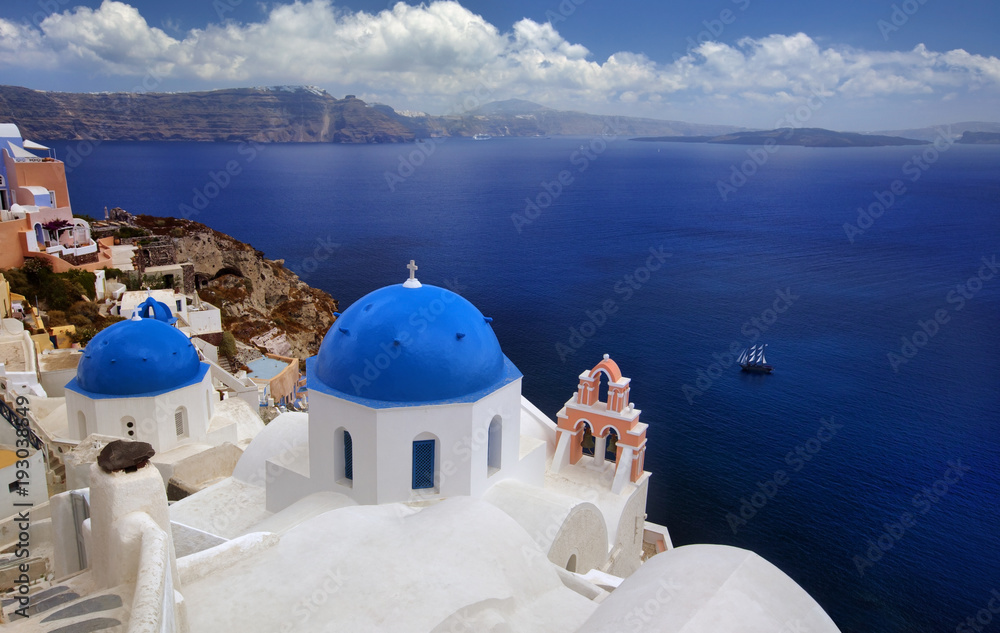 Blue dome church of beautiful Oia in Greek Island of Santorini, Greece