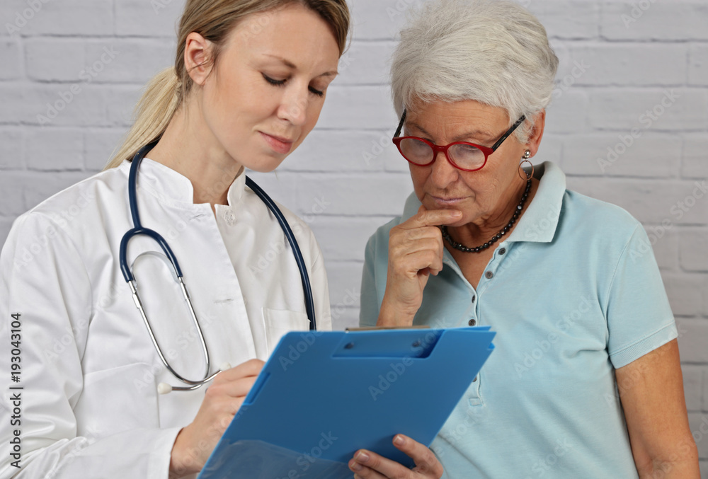 Female doctor showing medical report to senior woman Female doctor showing medical report to senior woman