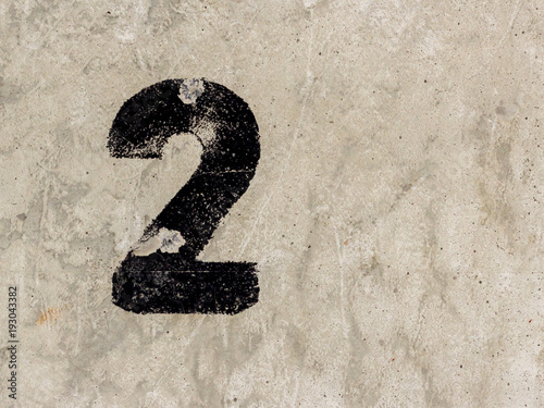 Number two 2 on concrete wall background