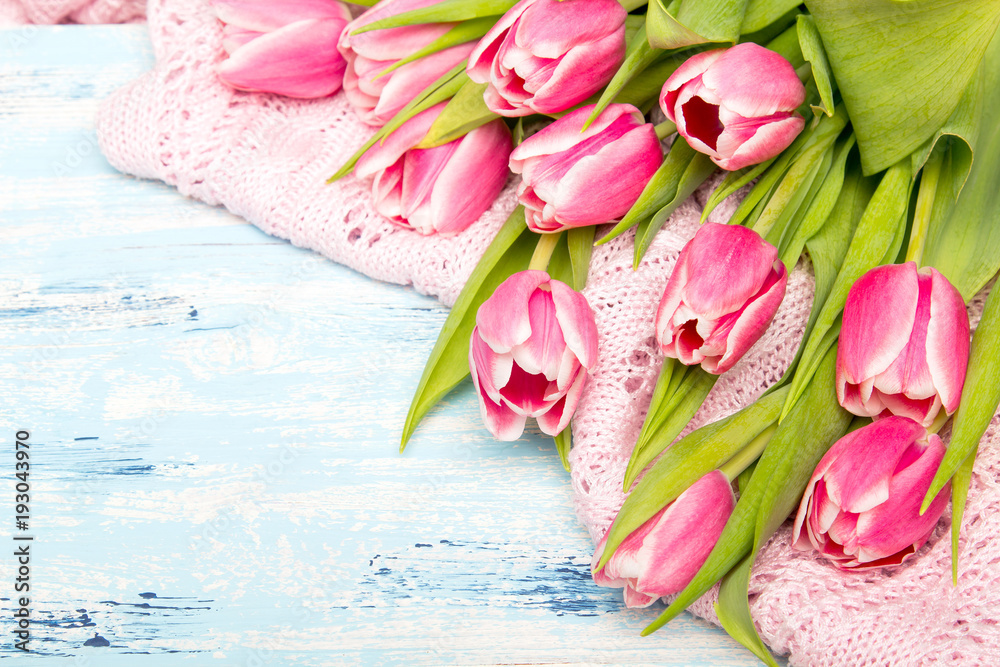 Pink tulip bouquet on blue wooden background, copy space. Beautiful flowers