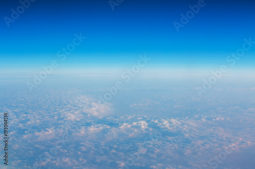 Flying above the clouds. Aerial view from the airplane