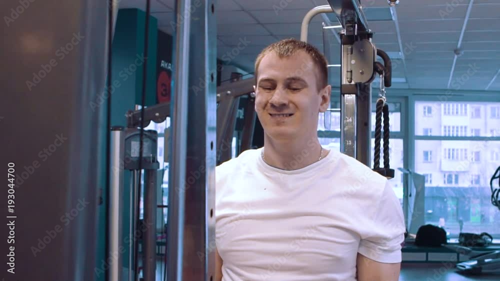 Fitness man doing a weight training by lifting heavy kettlebell. Yong athlete doing kettlebell swings. Bodybuilder lifting kettlebell Fitness man doing a weight training by lifting heavy kettlebell. Yong athlete doing kettlebell swings. Bodybuilder lifting kettlebell