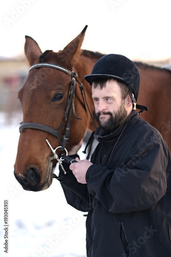 Down syndrome man with horse. Hippotherapy