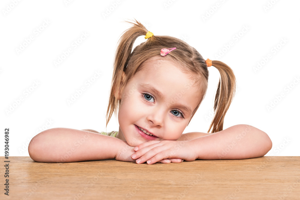 Portrait of a cute little girl lying on a table on her hands isolated on a white  background Stock Photo | Adobe Stock