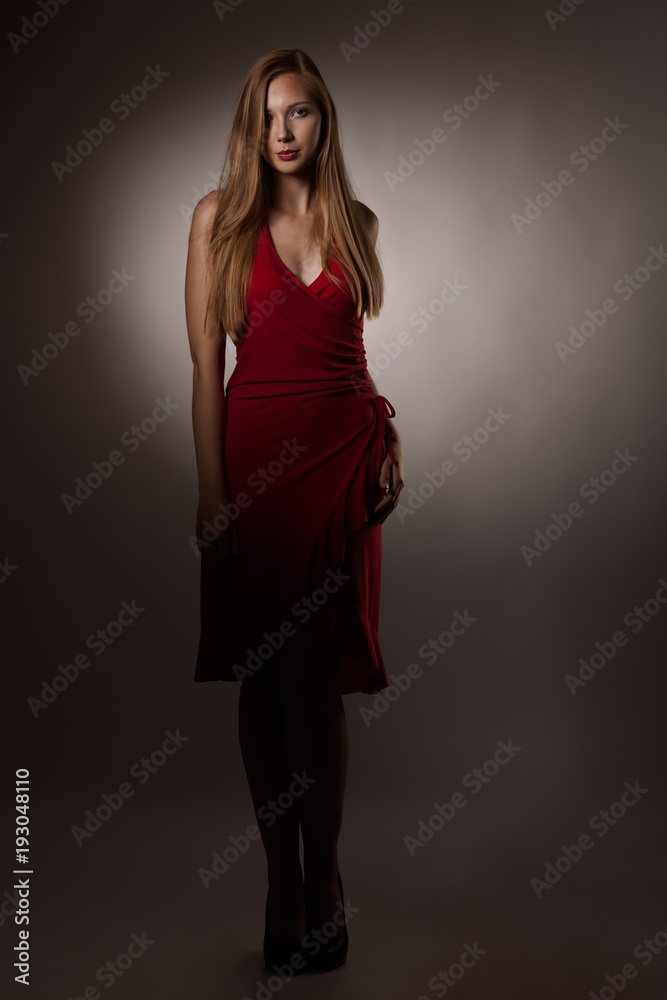 Moody studio portrait of a beautiful young brunette woman with long hair Moody studio portrait of a beautiful young brunette woman with long hair