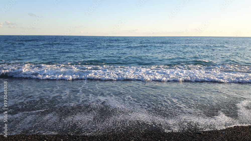Amazing caption of the seaside of Varazze in winter with some waves and some wind and a beautiful blue sky