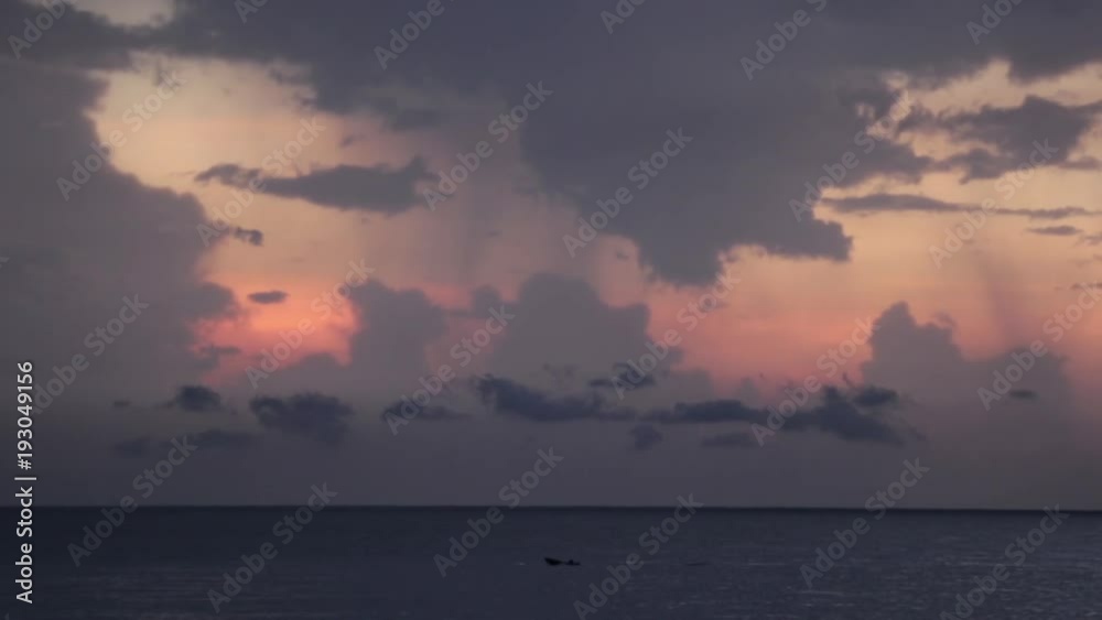Clouds over sunset and ocean with boat Clouds over sunset and ocean with boat