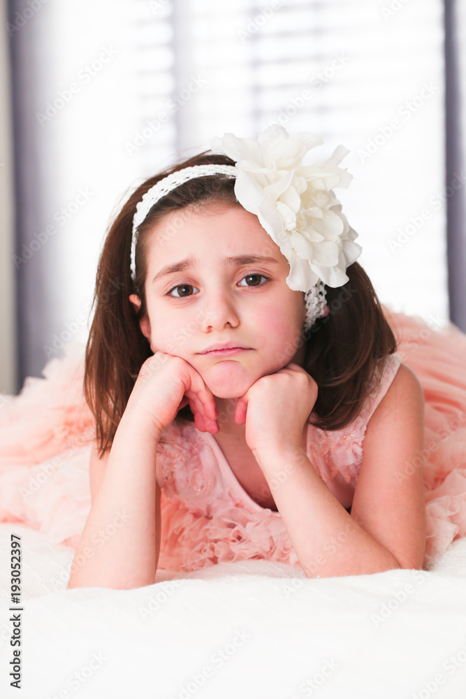 6 or 7 Years Old Little girl with Dark Hair and Brown Eyes, with White  Flower Headband,Funny Expression, sad, angry, posing isolated on blurry  background Stock Photo | Adobe Stock
