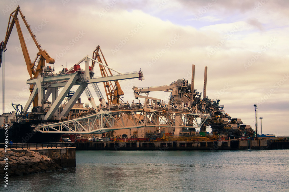 Cargo cranes in the dock of the industrial port.Spain, Cadiz, February 2018.