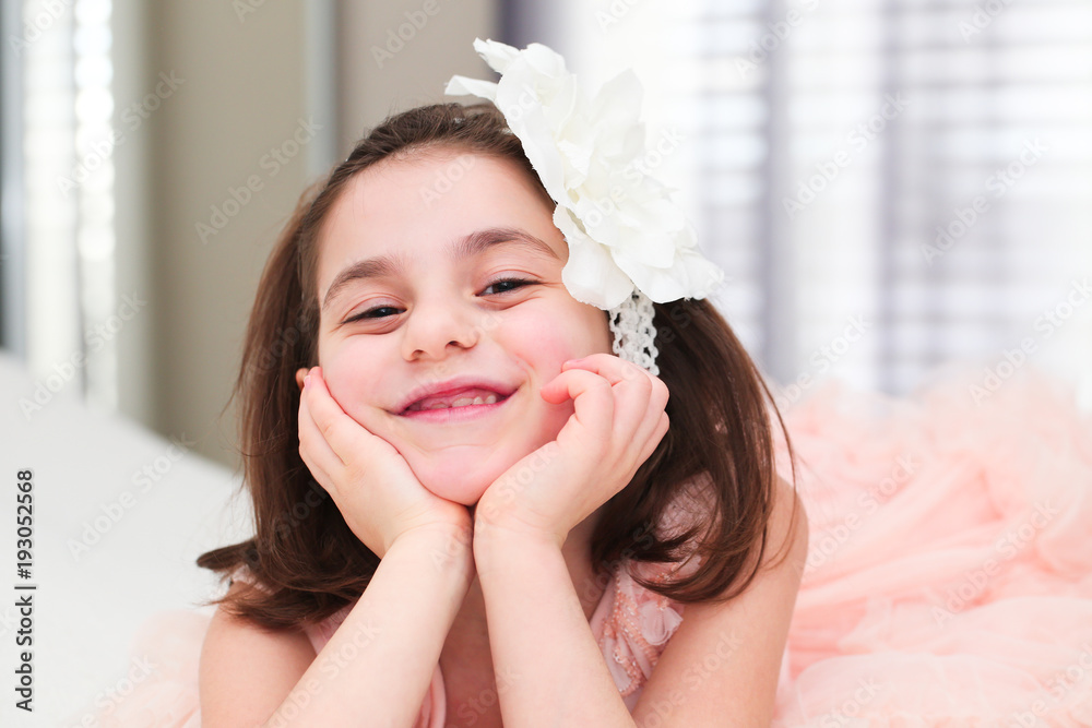 6 or 7 Years Old x girl with Dark Hair and Brown Eyes, with White Flower  Headband,Funny Expression, smiling, happy posing isolated on blurry  background Stock Photo | Adobe Stock