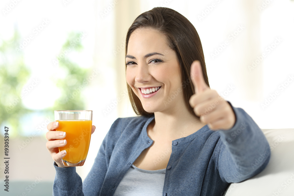 Satisfied consumer holding an orange juice glass Satisfied consumer holding an orange juice glass