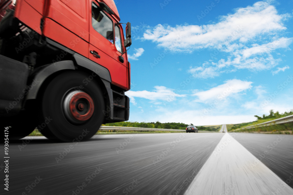 Big truck in motion on the countryside road against sky Big truck in motion on the countryside road against sky