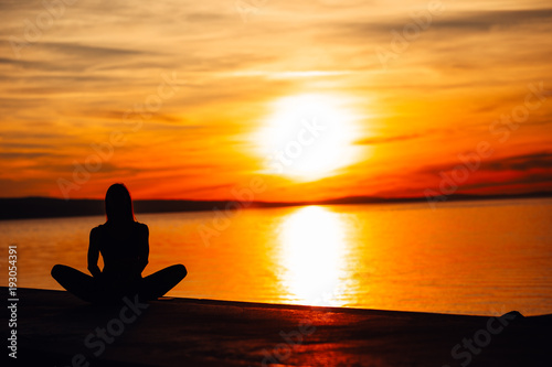 Carefree calm woman meditating in nature.Finding inner peace.Yoga practice.Spiritual healing lifestyle.Enjoying peace,anti-stress therapy,mindfulness meditation.Positive energy.Lotus pose