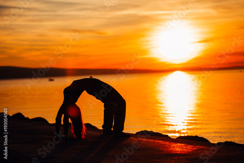 Carefree calm woman meditating in nature.Finding inner peace.Yoga practice.Spiritual healing lifestyle.Enjoying peace,anti-stress therapy,mindfulness meditation.Positive energy.Bridge wheel pose