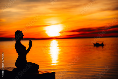 Carefree calm woman meditating in nature.Finding inner peace.Yoga practice.Spiritual healing lifestyle.Enjoying peace,anti-stress therapy,mindfulness meditation.Positive energy.Chakra balancing