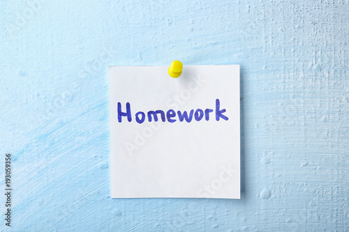Note with word "Homework" pinned to wall