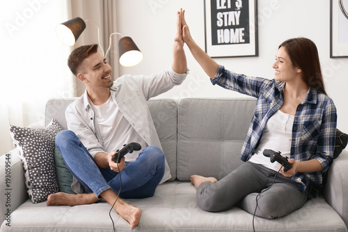 Young couple playing video ...