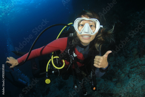 Scuba dive. Young Asian woman scuba diving