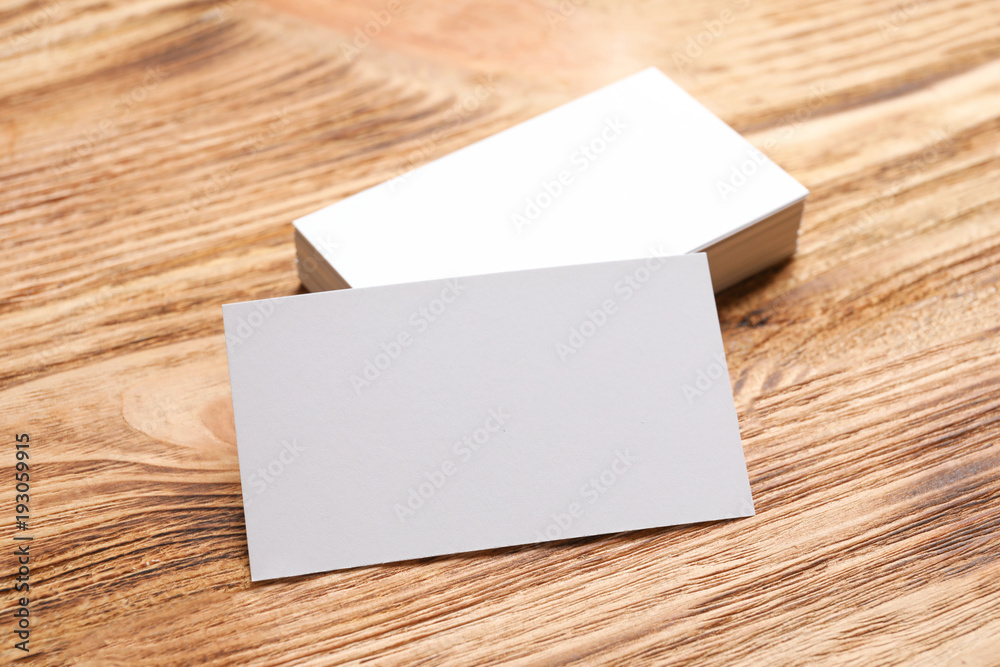 Blank business cards on wooden background