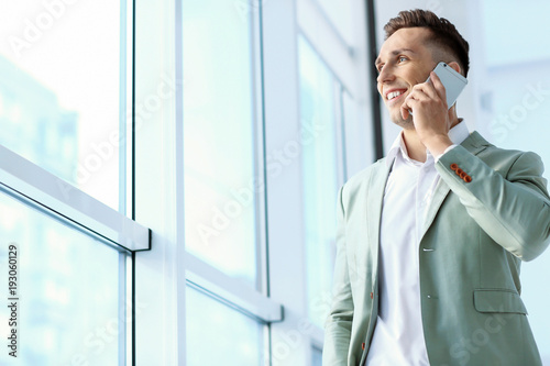 Young man talking on phone ...