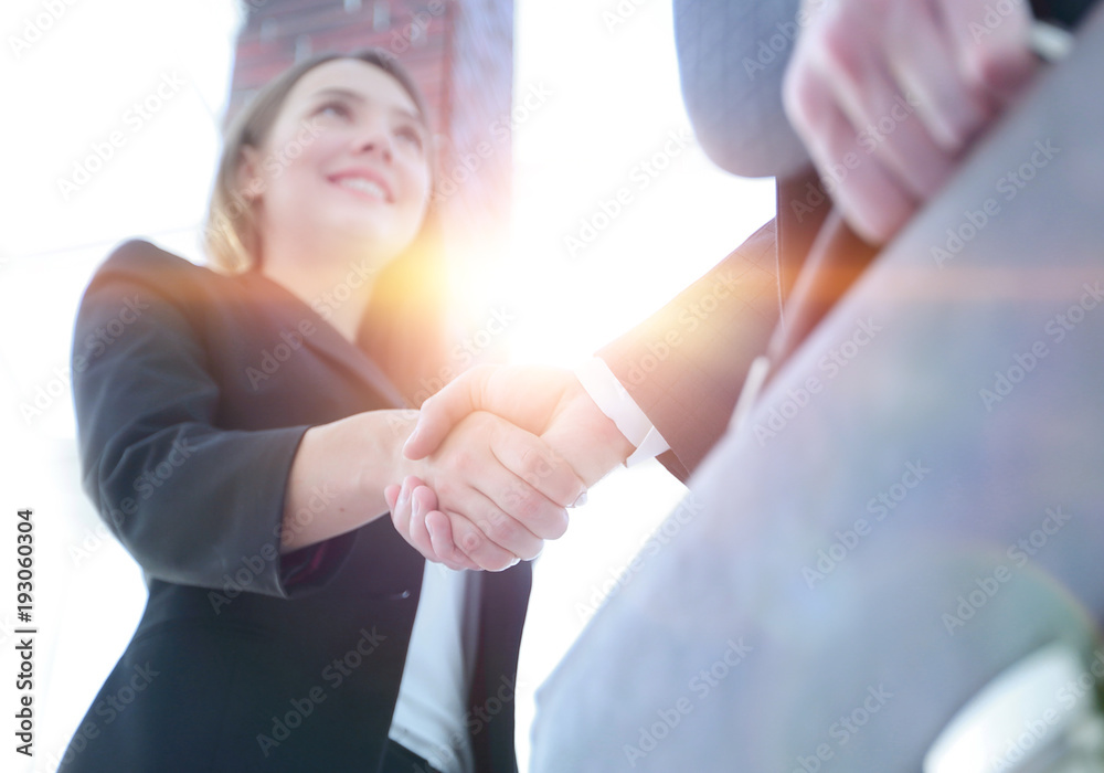 Close up of businessman and businesswoman shaking hands