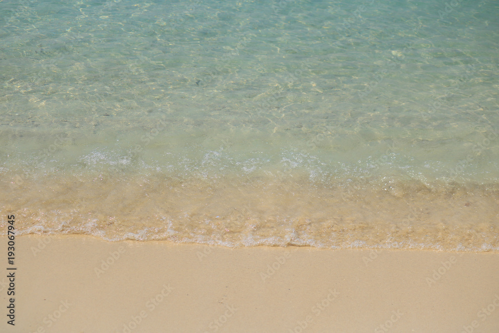 Soft Wave Of Blue Ocean On Sandy Beach. Background. Selective focus. Soft Wave Of Blue Ocean On Sandy Beach. Background. Selective focus.