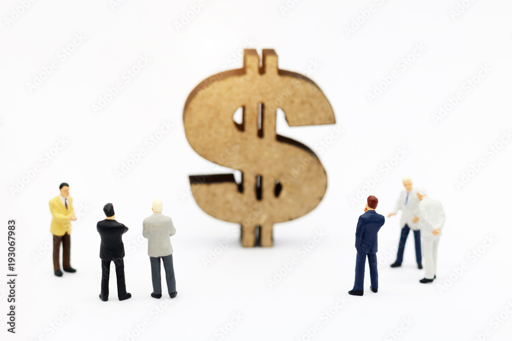 Miniature people: Business team looking dollor sign. Finance and growth in business concept Miniature people: Business team looking dollor sign. Finance and growth in business concept