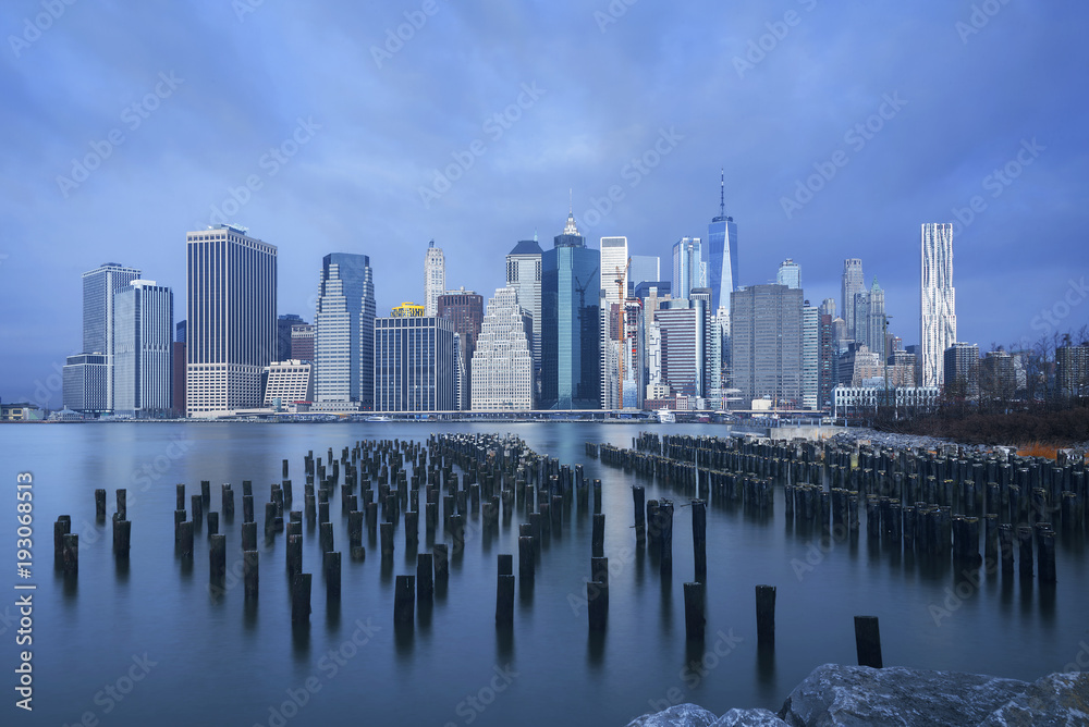 Naklejka premium Skyline of Manhattan on cloudy sky as background