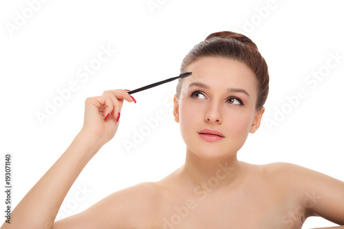 girl applies cosmetics