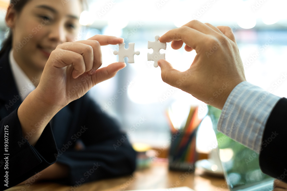business people meeting brainstorming and using white puzzle pieces being fitted together, teamwork concept business people meeting brainstorming and using white puzzle pieces being fitted together, teamwork concept