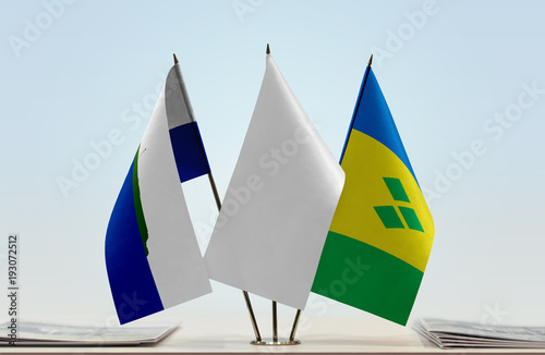 Flags of Navassa Island and Saint Vincent and the Grenadines with a white flag in the middle photo