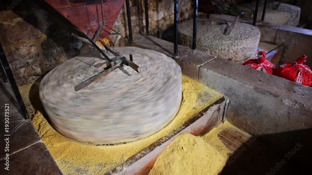 Old water powered working ancient stone mill for flour