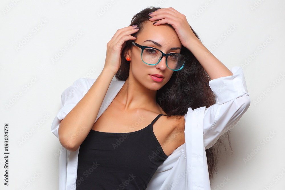 young girl in stylish glasses on a light background young girl in stylish glasses on a light background
