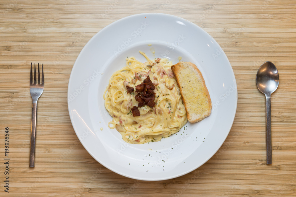 Top view of pasta carbonara with bacon on wooden background. Top view of pasta carbonara with bacon on wooden background.