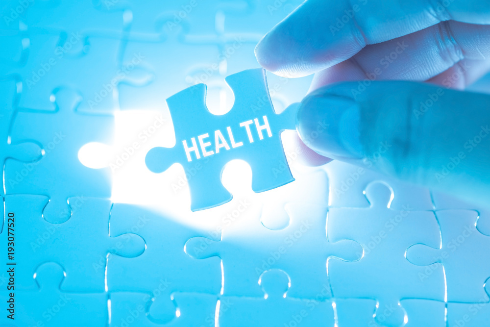 Doctor hand holding a jigsaw puzzle with health word. Concept Healthy. Doctor hand holding a jigsaw puzzle with health word. Concept Healthy.
