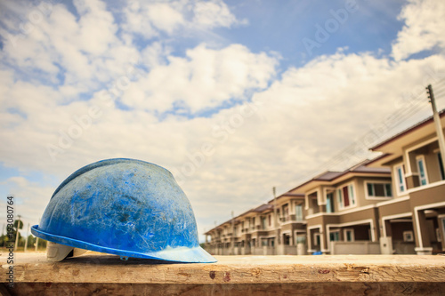 Blue hard hat on house building construction site