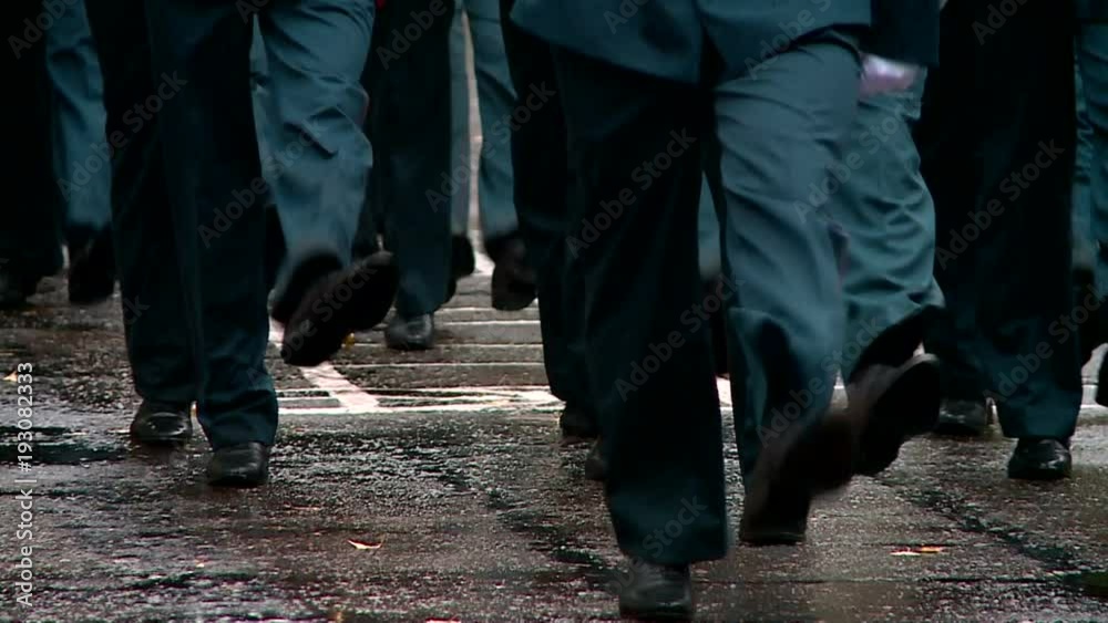military marching on the parade ground in the rain feet in the frame
