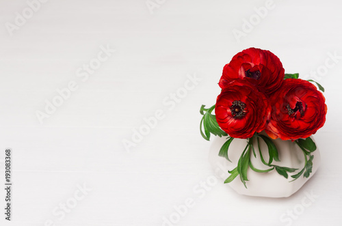 Luxury deep red three flowers in ceramic vase on white wood background. Romantic decor.