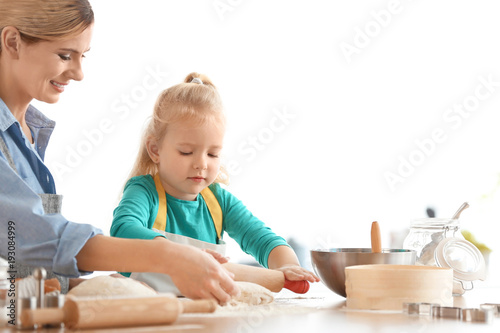 Mother and daughter with do...