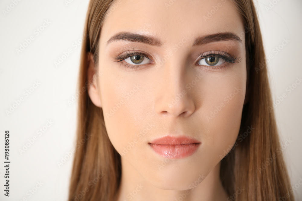 Young woman with eyelash loss problem on white background