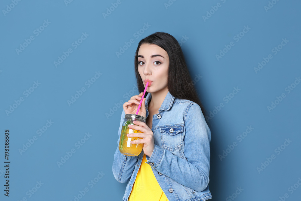 Young woman with tasty refreshing lemonade on color background Young woman with tasty refreshing lemonade on color background