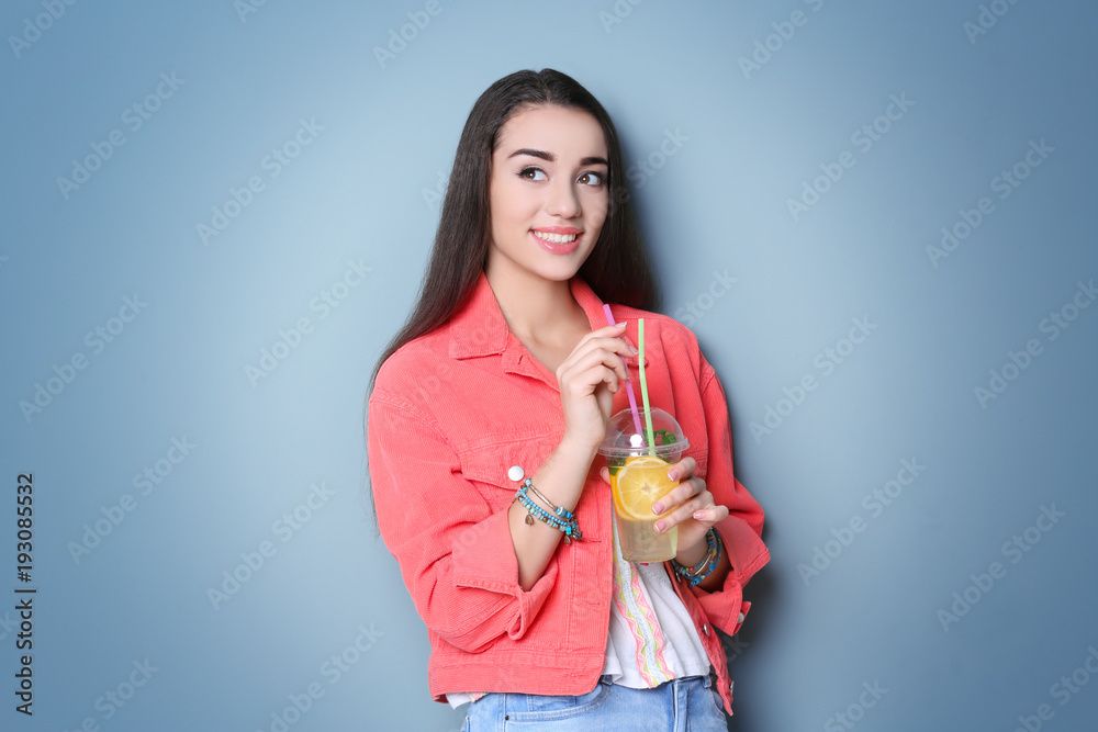 Young woman with tasty refreshing lemonade on color background Young woman with tasty refreshing lemonade on color background