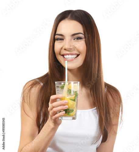 Beautiful young woman drink...
