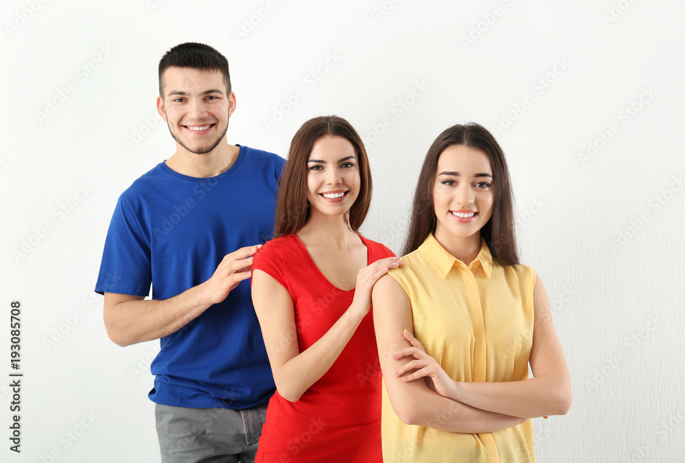 Young people posing together on light background. Unity concept Young people posing together on light background. Unity concept